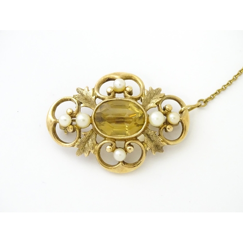 624 - A 9ct gold brooch with foliate detail set with central citrine, and pearls to border. Approx. 1 1/2