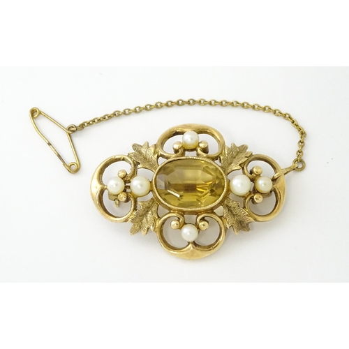 624 - A 9ct gold brooch with foliate detail set with central citrine, and pearls to border. Approx. 1 1/2