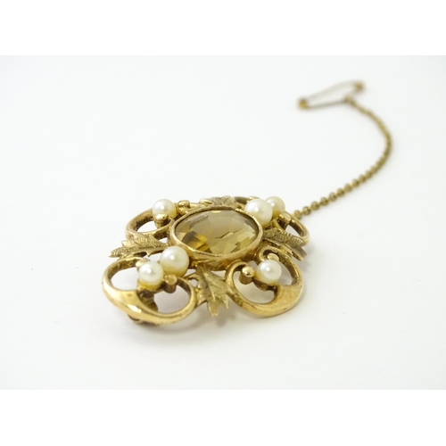 624 - A 9ct gold brooch with foliate detail set with central citrine, and pearls to border. Approx. 1 1/2