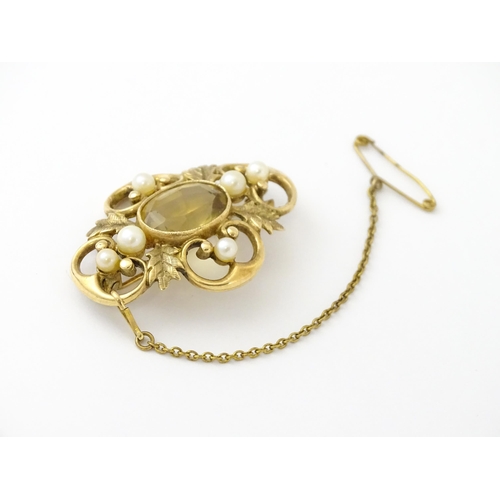 624 - A 9ct gold brooch with foliate detail set with central citrine, and pearls to border. Approx. 1 1/2