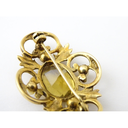 624 - A 9ct gold brooch with foliate detail set with central citrine, and pearls to border. Approx. 1 1/2