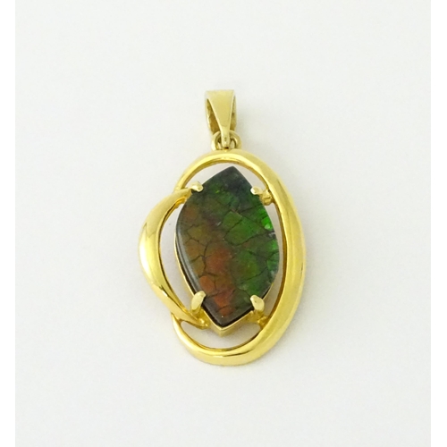 627 - A gold pendant set with ammolite. Approx. 1