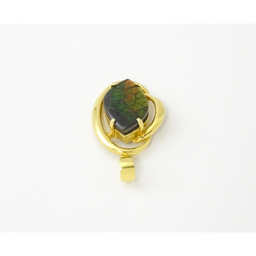 627 - A gold pendant set with ammolite. Approx. 1