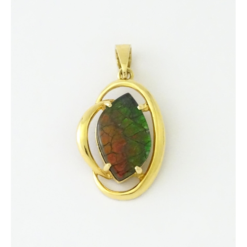 627 - A gold pendant set with ammolite. Approx. 1