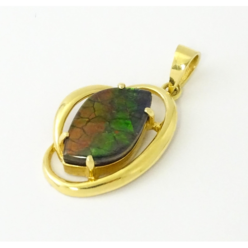 627 - A gold pendant set with ammolite. Approx. 1