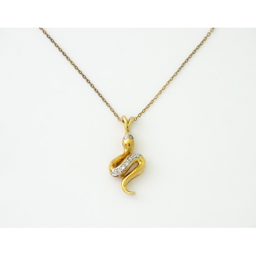 628 - A 9ct gold pendant of snake / serpent form set with diamonds, on a 9ct gold chain. Pendant approx. 1... 