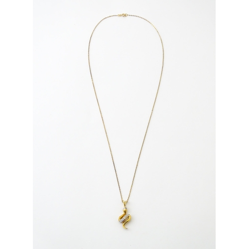 628 - A 9ct gold pendant of snake / serpent form set with diamonds, on a 9ct gold chain. Pendant approx. 1... 