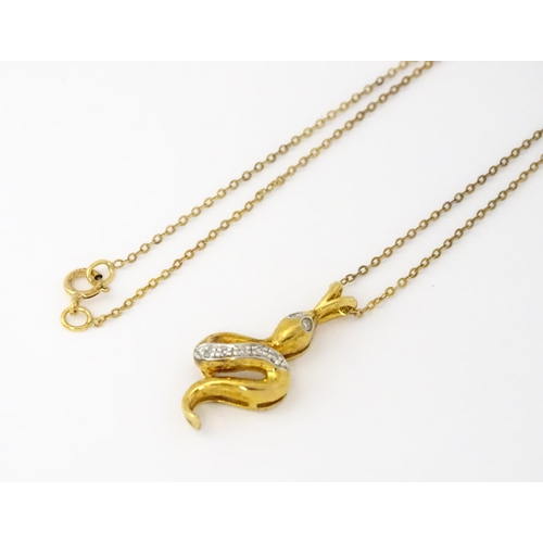 628 - A 9ct gold pendant of snake / serpent form set with diamonds, on a 9ct gold chain. Pendant approx. 1... 