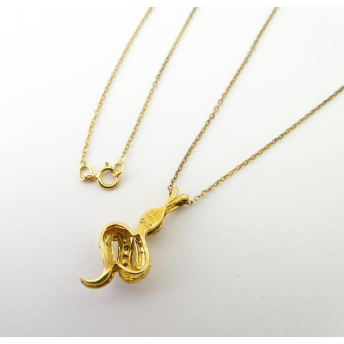 628 - A 9ct gold pendant of snake / serpent form set with diamonds, on a 9ct gold chain. Pendant approx. 1... 