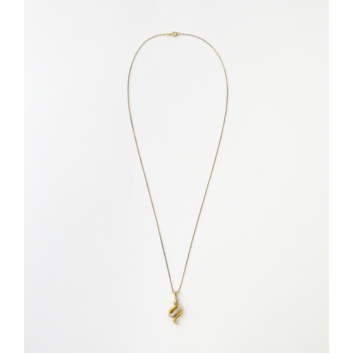 628 - A 9ct gold pendant of snake / serpent form set with diamonds, on a 9ct gold chain. Pendant approx. 1... 