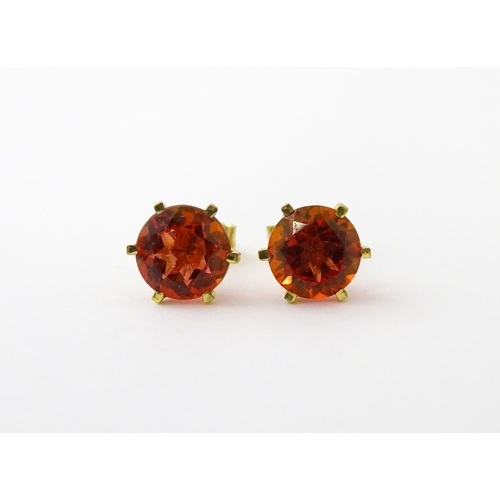 631 - A pair of silver gilt stud earrings set with coloured topaz. Approx. 1/4