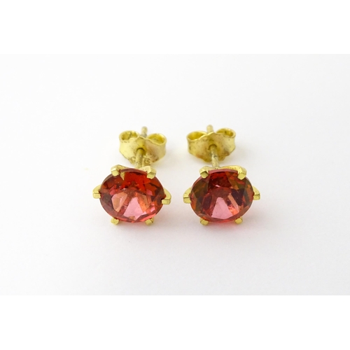 631 - A pair of silver gilt stud earrings set with coloured topaz. Approx. 1/4