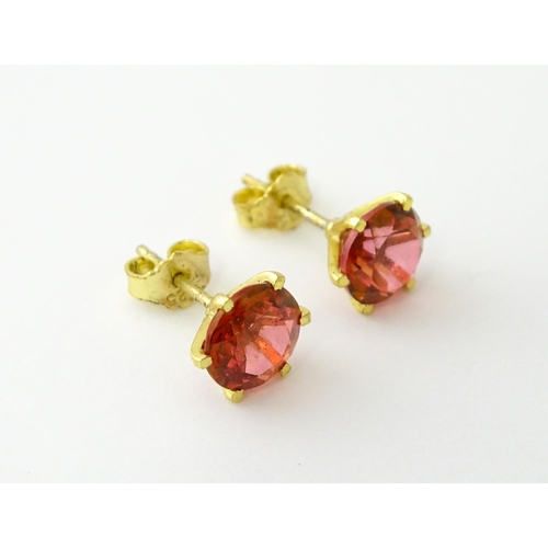 631 - A pair of silver gilt stud earrings set with coloured topaz. Approx. 1/4