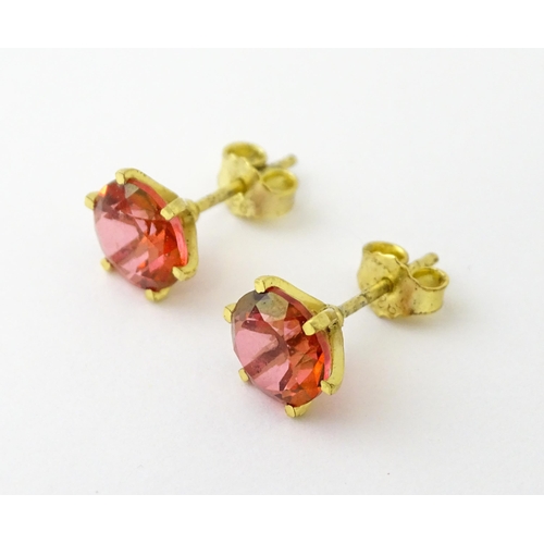 631 - A pair of silver gilt stud earrings set with coloured topaz. Approx. 1/4