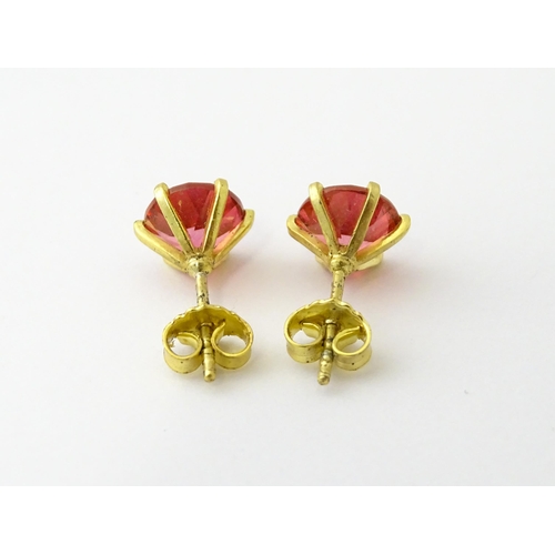 631 - A pair of silver gilt stud earrings set with coloured topaz. Approx. 1/4