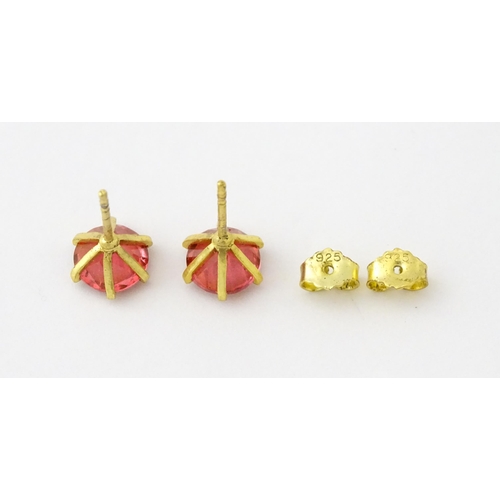 631 - A pair of silver gilt stud earrings set with coloured topaz. Approx. 1/4