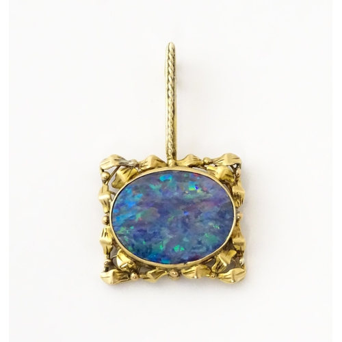 633 - A 9ct gold pendant set with central opal. Approx. 1 1/2