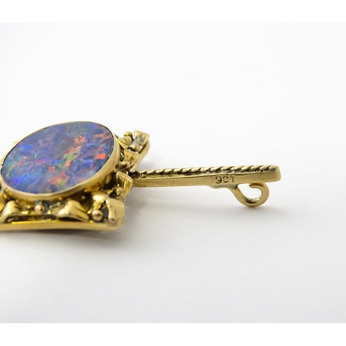 633 - A 9ct gold pendant set with central opal. Approx. 1 1/2