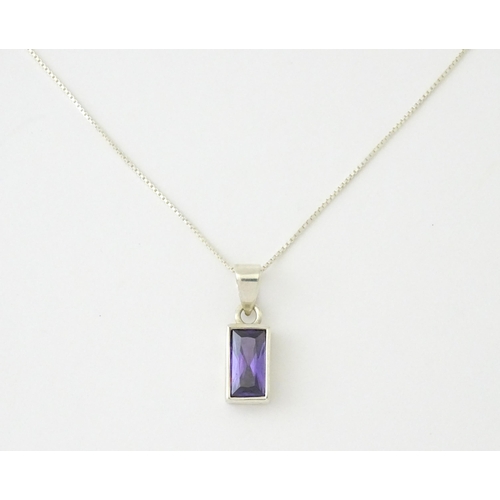 635 - A silver pendant set with central amethyst, on a .925 silver chain. Pendant approx. 3/4