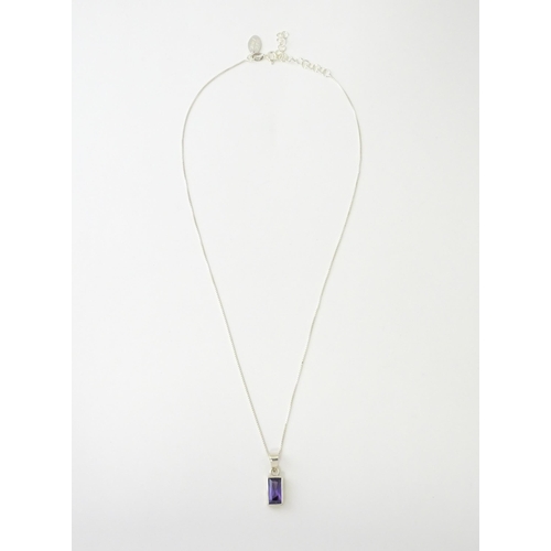 635 - A silver pendant set with central amethyst, on a .925 silver chain. Pendant approx. 3/4