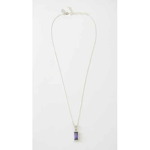 635 - A silver pendant set with central amethyst, on a .925 silver chain. Pendant approx. 3/4