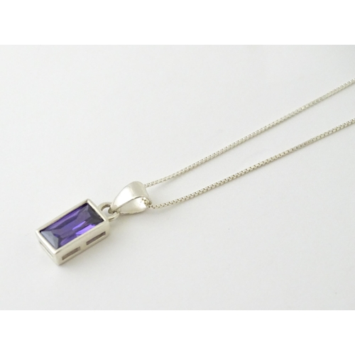 635 - A silver pendant set with central amethyst, on a .925 silver chain. Pendant approx. 3/4