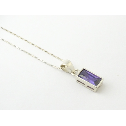 635 - A silver pendant set with central amethyst, on a .925 silver chain. Pendant approx. 3/4