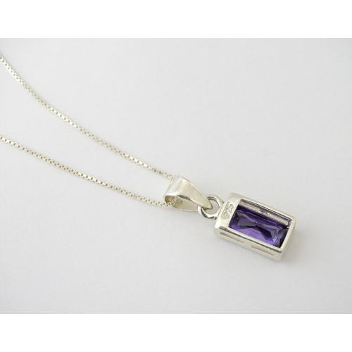 635 - A silver pendant set with central amethyst, on a .925 silver chain. Pendant approx. 3/4