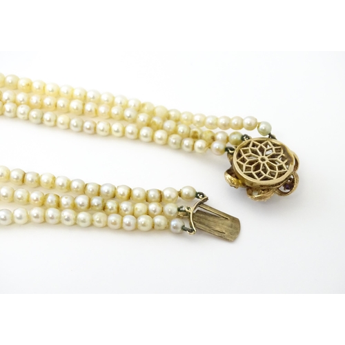 637 - A three strand graduated cultured pearl necklace with 9ct gold cluster snap clasp set with 6 culture... 