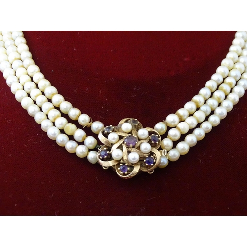 637 - A three strand graduated cultured pearl necklace with 9ct gold cluster snap clasp set with 6 culture... 