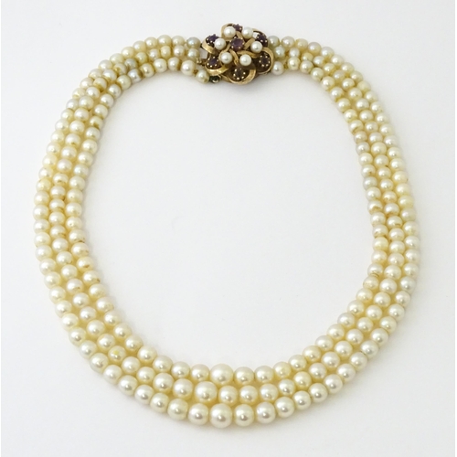 637 - A three strand graduated cultured pearl necklace with 9ct gold cluster snap clasp set with 6 culture... 