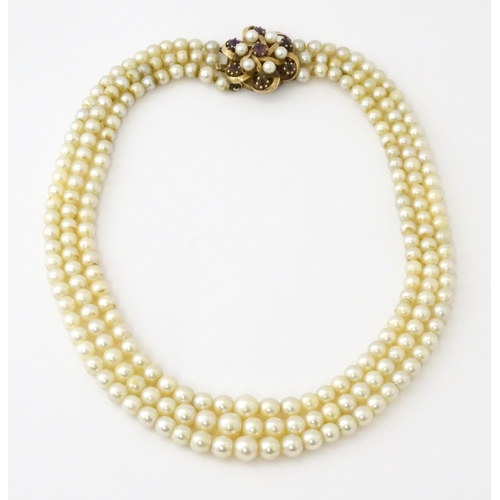 637 - A three strand graduated cultured pearl necklace with 9ct gold cluster snap clasp set with 6 culture... 