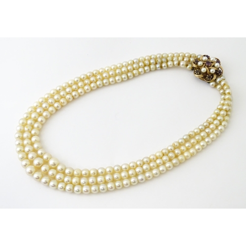 637 - A three strand graduated cultured pearl necklace with 9ct gold cluster snap clasp set with 6 culture... 