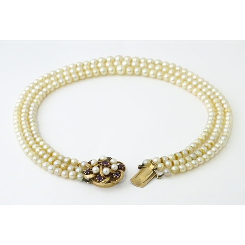 637 - A three strand graduated cultured pearl necklace with 9ct gold cluster snap clasp set with 6 culture... 