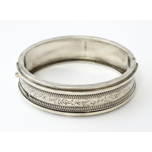 645 - A Victorian silver bracelet of bangle form hallmarked Birmingham 1882, maker Revell & Co.