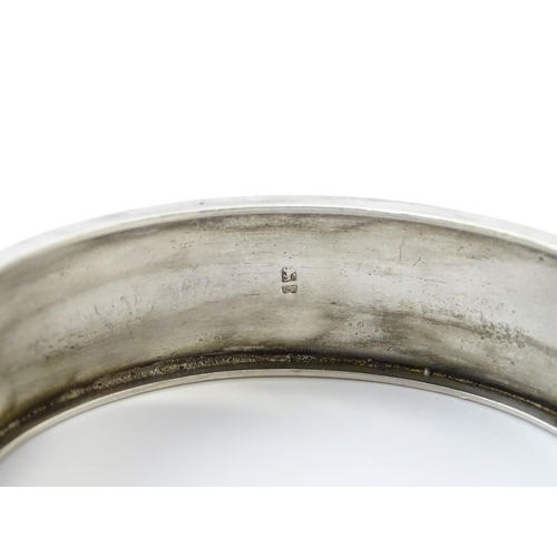 645 - A Victorian silver bracelet of bangle form hallmarked Birmingham 1882, maker Revell & Co.