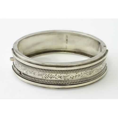 645 - A Victorian silver bracelet of bangle form hallmarked Birmingham 1882, maker Revell & Co.