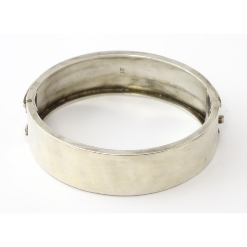 645 - A Victorian silver bracelet of bangle form hallmarked Birmingham 1882, maker Revell & Co.