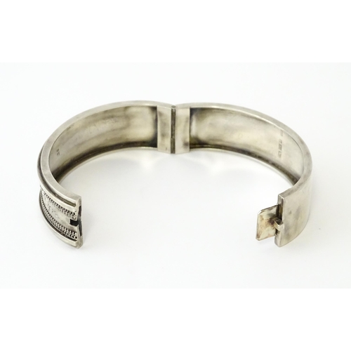 645 - A Victorian silver bracelet of bangle form hallmarked Birmingham 1882, maker Revell & Co.