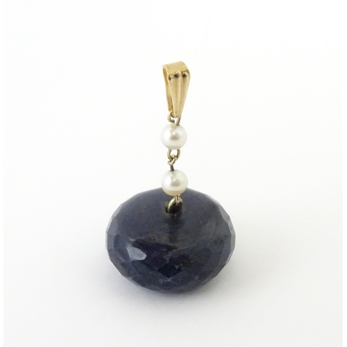 649 - A pendant set with large facet cut sapphire bead and pearls. Approx. 1 1/4