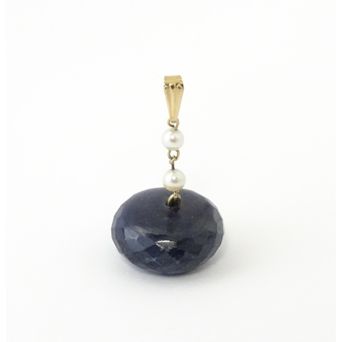 649 - A pendant set with large facet cut sapphire bead and pearls. Approx. 1 1/4