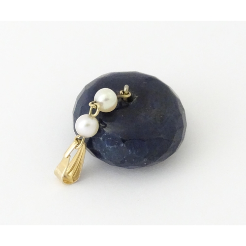 649 - A pendant set with large facet cut sapphire bead and pearls. Approx. 1 1/4