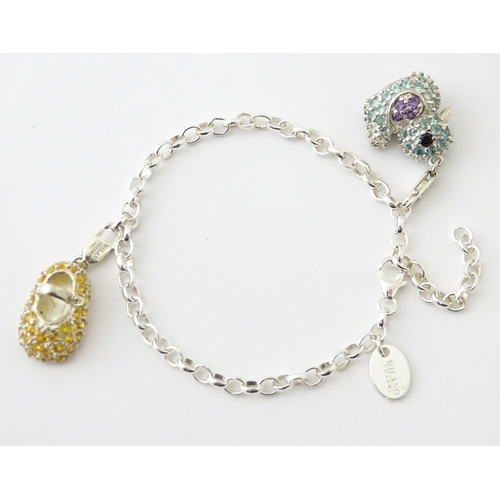 656 - An Italian silver charm bracelet set with two charms one formed as a duck, the other as a child's sh... 