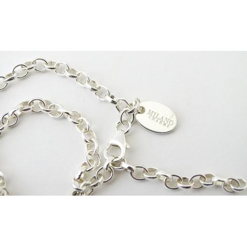 656 - An Italian silver charm bracelet set with two charms one formed as a duck, the other as a child's sh... 