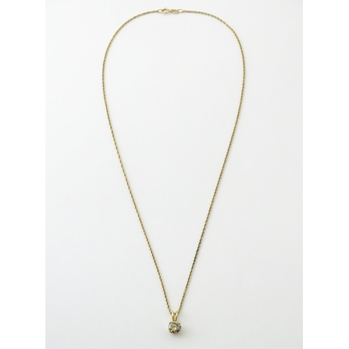 659 - A 14ct gold chain with pendant set with brown diamond. Diamond approx. 4mm, Chain approx. 18