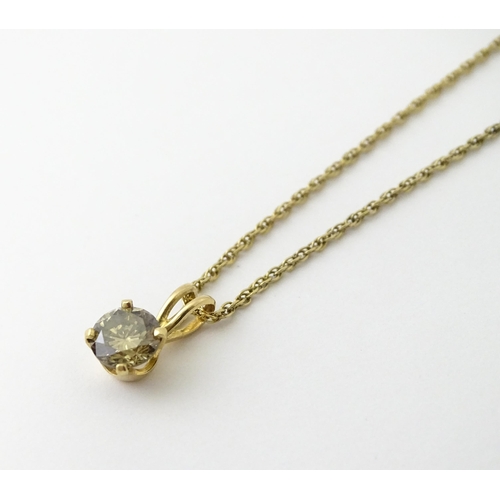 659 - A 14ct gold chain with pendant set with brown diamond. Diamond approx. 4mm, Chain approx. 18