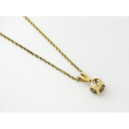 659 - A 14ct gold chain with pendant set with brown diamond. Diamond approx. 4mm, Chain approx. 18