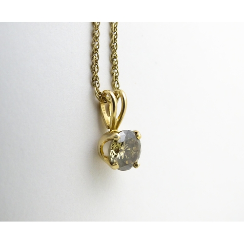 659 - A 14ct gold chain with pendant set with brown diamond. Diamond approx. 4mm, Chain approx. 18