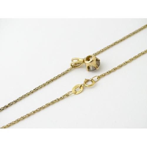 659 - A 14ct gold chain with pendant set with brown diamond. Diamond approx. 4mm, Chain approx. 18