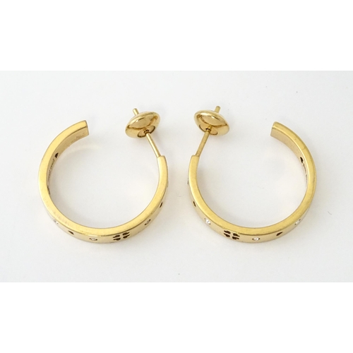 661 - A pair of gilt metal hoop earrings set with white stones by Folli Follie. Approx. 1